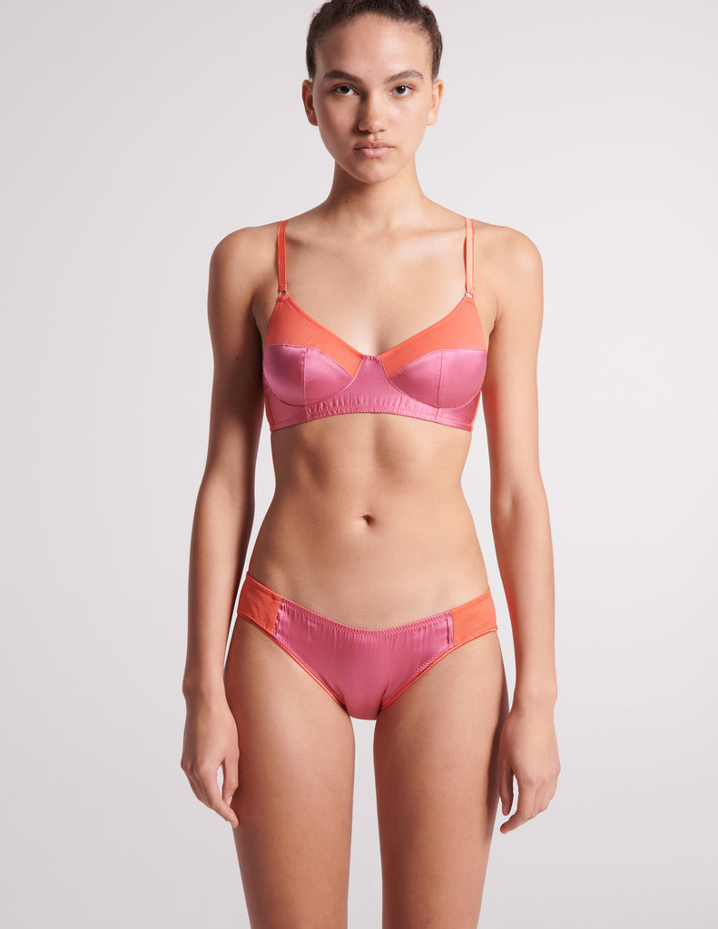 On model image of orange cotton with pink silk bralette and orange cotton with pink silk panty.