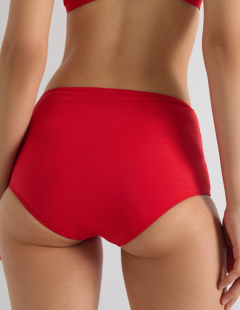 Model wearing Araks Ulija bikini top and Mallory bikini bottom in scarlet