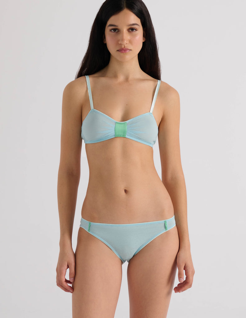 A model in the araks uma bralette and harriet panty in verona blue