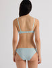 A model in the araks uma bralette and harriet panty in verona blue