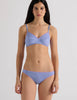 A model in the araks antonia bralette and isabella panty in rococo blue