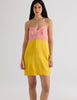 A model in the araks silk charmeuse holly slip in pomelo yellow