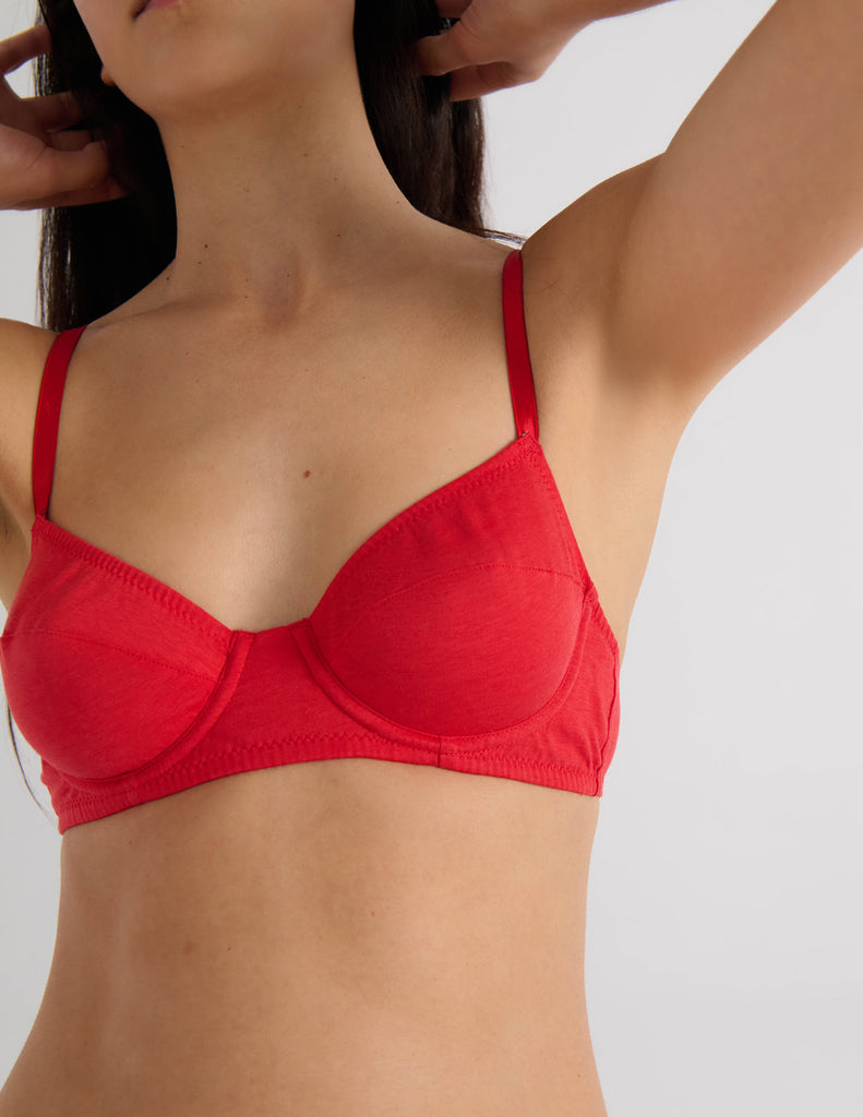 A model in the araks beau underwire bra in recycled cotton in scarlet red