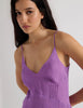 A model in the araks silk cadel slip in viola purple