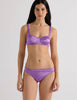 A model in the araks silk charmeuse penelope bralette and grier thong in viola purple