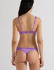 A model in the araks silk charmeuse penelope bralette and grier thong in viola purple