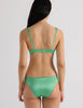 A model in the araks silk charmeuse penelope bralette and gwyneth panty in cypress green