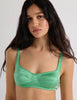 A model in the araks silk charmeuse penelope bralette and gwyneth panty in cypress green
