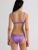A model in the araks silk penelope bralette and gwyneth panty in viola purple