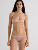 A model in the araks silk quintana bralette and quincy panty in bare