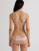 A model in the araks silk quintana bralette and quincy panty in bare