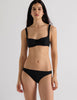 Model wearing Araks Ulija bikini top and Piper bikini bottoms in black