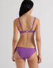 Model wearing the Araks Ulija bikini top and Piper bikini bottom in violet