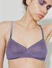 A model wearing the Araks Antonia bralette in the shade violette. 