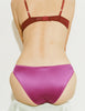 A model wearing Willow bralette in Raspberry paired with Gwyneth panty against a plain light gray background.