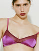 A model wearing Araks Beatrice bralette in Raspberry.