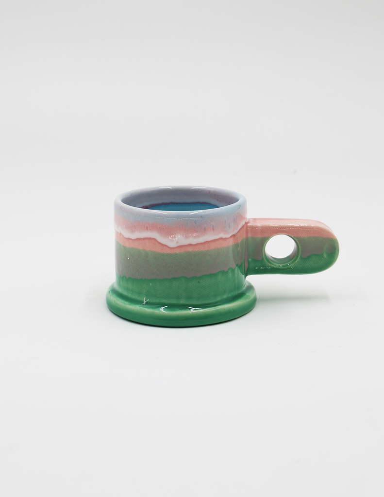 Peter Shire pink and green mugs against a white background. 