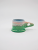 Peter Shire pink and green mugs against a white background. 