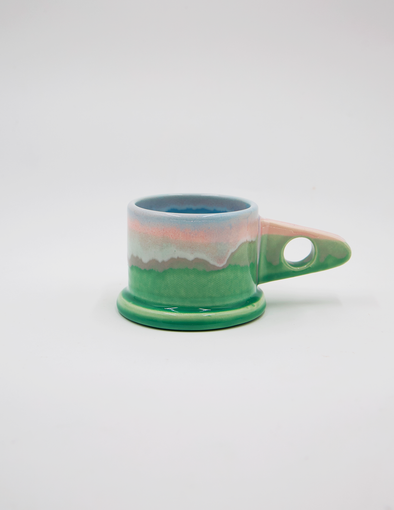 Peter Shire pink and green mugs against a white background. 