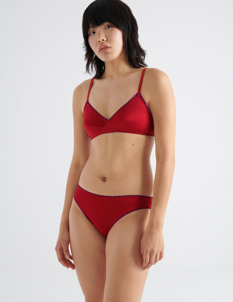 on model three quarter view of woman in red cotton bra and panty