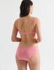 Back view image of model wearing pink cotton hipster panty with yellow trim and matching bralette. 