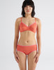 front view of woman in orange cotton bra and hipster 