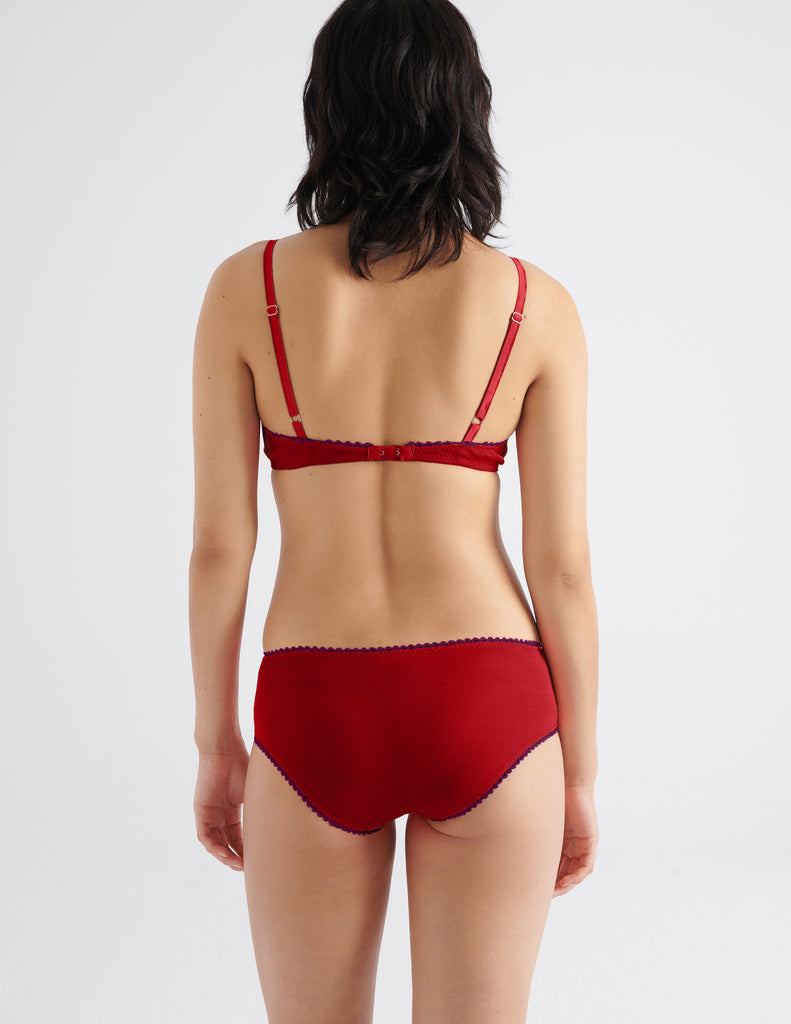 on model back view of woman in red bra and panty