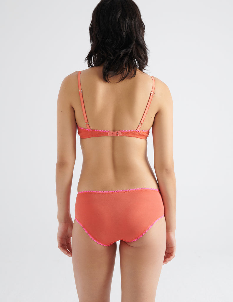 back view of woman in orange cotton bra and hipster 