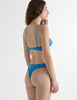 Back view of the model wearing iris blue antonia cotton bra with stella thong