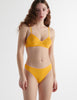 Front view of the woman wearing antonia orange marigold cotton bra with stella thong