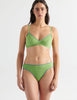 Front view image of model wearing green cotton thong with blue trim and matching bralette. 