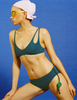 A model in the araks elias bikini top in ezra hipster in fern