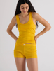 A model in the araks organic cotton james tank and presley short in pomelo yellow