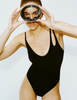 A model in the araks jamie one piece in black