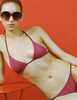 A model in the araks nelle bikini top and nadia bikini bottom in cerise