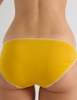 A model in the araks organic cotton isabella panty in pomelo yellow
