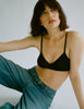 A model in the Araks organic cotton antonia bralette in black