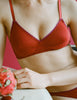A model in the Araks organic cotton antonia bralette and isabella panty in clay red