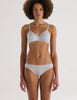 A model in the araks organic cotton antonia bralette and isabella panty in fondant blue