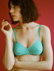 A model in the Araks organic cotton antonia bralette in glass green