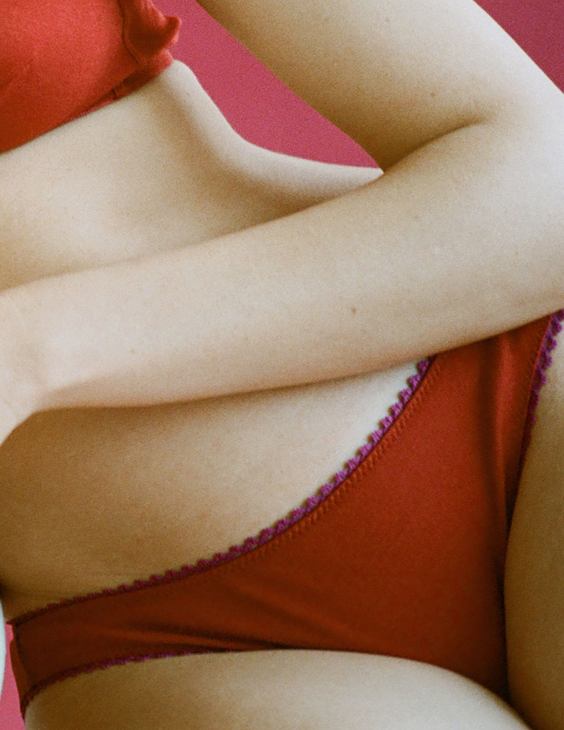 A model in the Araks organic cotton isabella panty in clay red