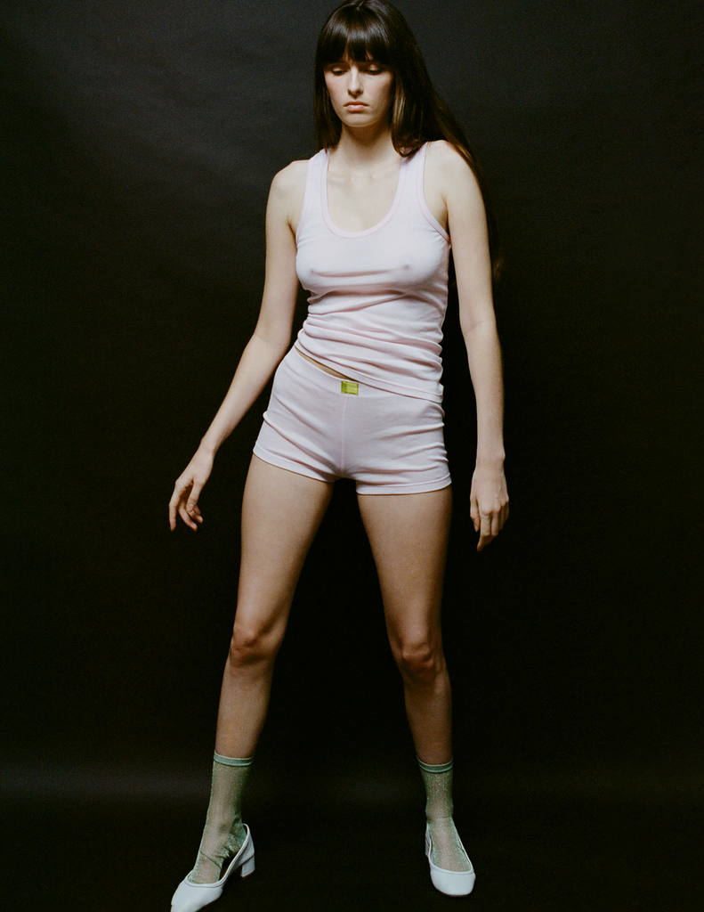 A model in the araks organic cotton james tank in confection