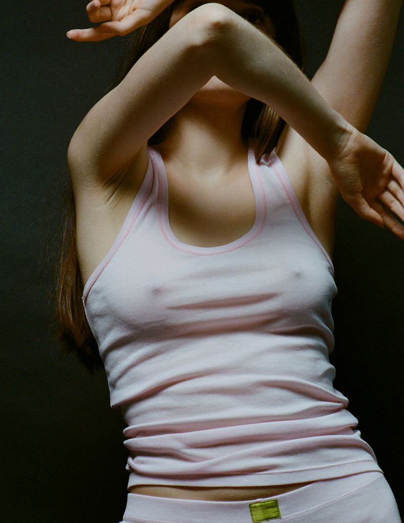 A model in the organic cotton james tank in confection pink