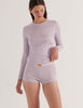 A model in the araks organic cotton sabine long sleeve and presley short in fairy purple