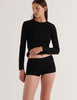 A model in the araks organic cotton sabine long sleeve and presley short in black