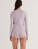 a model in the araks organic cotton sabine long sleeve and presley short in fairy lavender