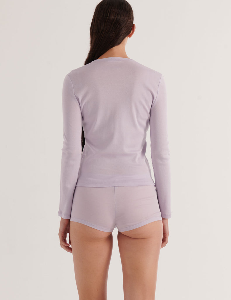 a model in the araks organic cotton sabine long sleeve and presley short in fairy lavender