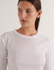 A model in the araks organic cotton sabine long sleeve shirt in white