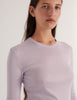 A model in the araks organic cotton sabine long sleeve in fairy purple