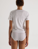 A model in the araks tavi short sleeve and isabella panty in white
